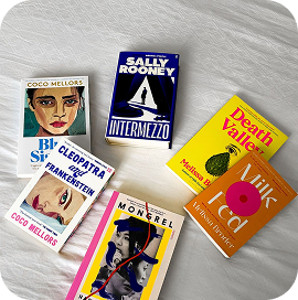 Books scattered on a bed