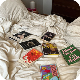 Books scattered on a bed